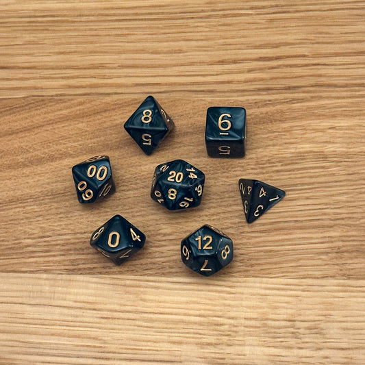 Set of 7 polyhedral dice (D4, D6, D8, D10, percentile D10, D12, D20) in swirled black acrylic with gold number infill.