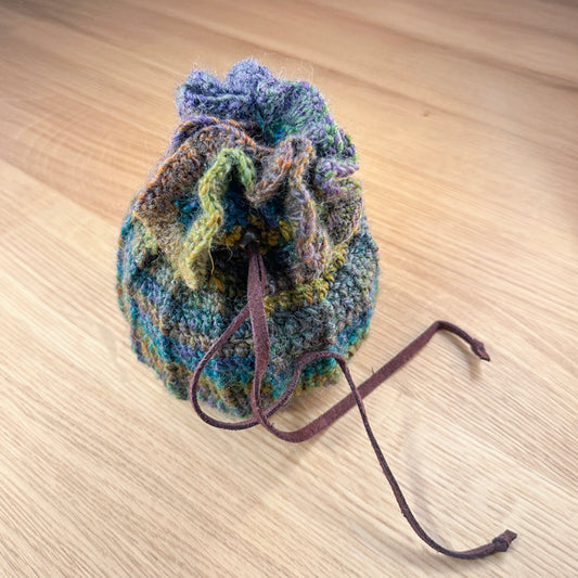 closed crochet pouch in green, blues and purples, part of the handmade hoard and Fateweaver's collection