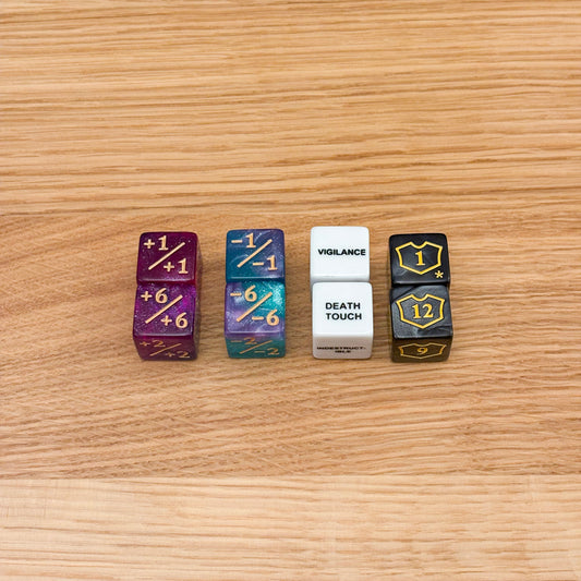 Colorful counter dice set, featuring purple +1/+1, teal -1/-1, a white keyword die with 'Vigilance' and 'Death Touch', and black loyalty counters with yellow shield symbols and numbers.