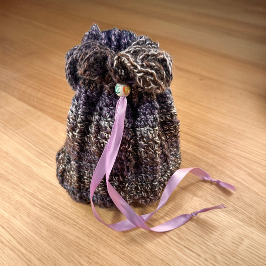 Closed crochet pouch in purple and white yarn, part of the handmade hoard and Fateweaver's collection